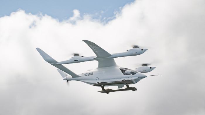 Beta Technologies' Alia 250 eVTOL flies across a partly cloudy sky