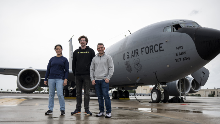 Merlin engineers Josie Cater, Nick Lepore, and Carl Pankok pose for a photo in front of a Boeing KC-135 Stratotanker