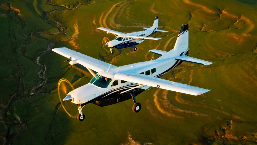 A digital rendering of a Cessna Caravan and Cessna Grand Caravan EX in flight