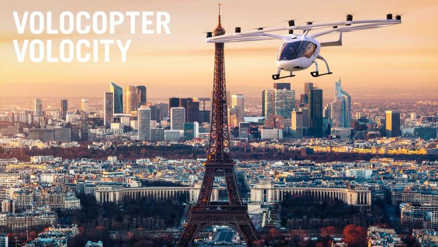 Rendering of Volocopter eVTOL aircraft flying above Paris with Eifel tower in background