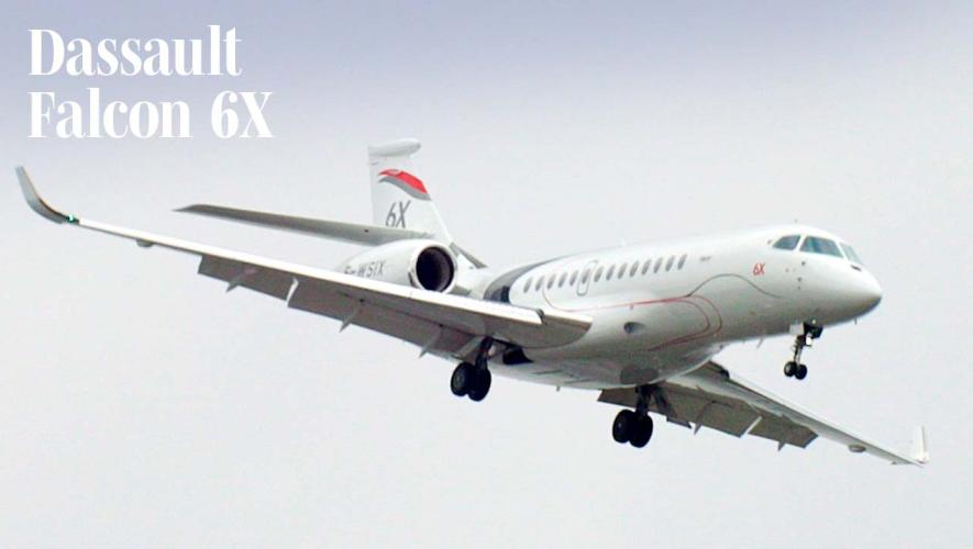 Dassault Falcon 6X business jet flying with landing gear down