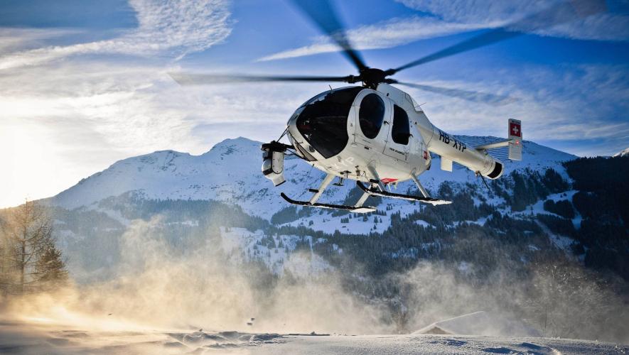 MD Helicopters MD520N inflight over snowy mountains