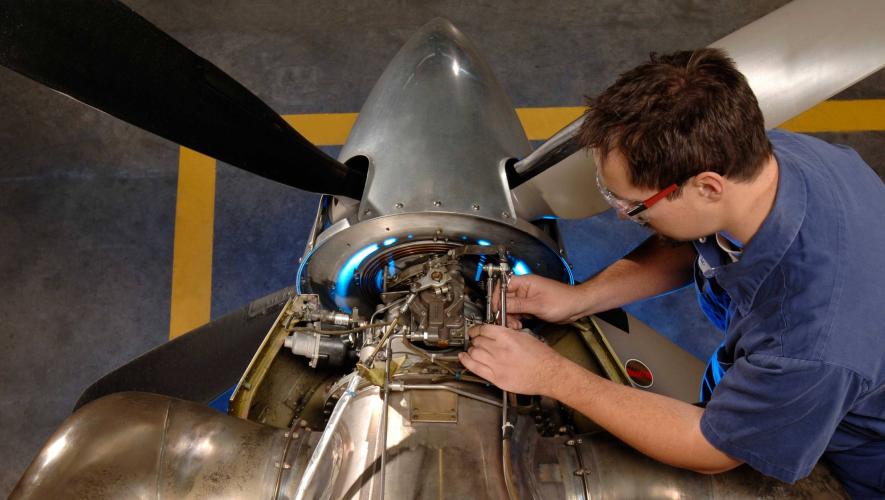 Pratt & Whitney technician working on PT6A engine