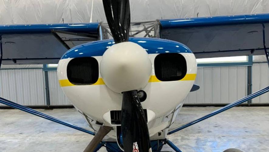 An image of a propeller attached to the front of a small plane. 