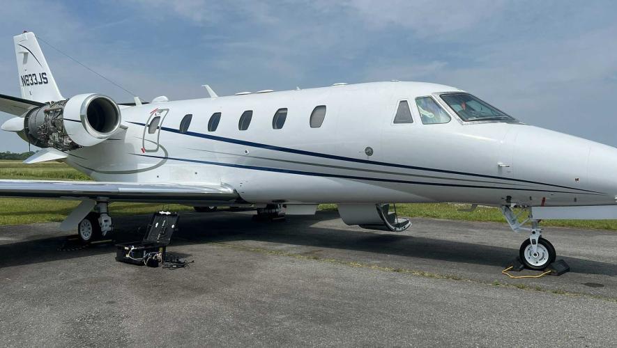 FlyExclusive's Cessna Citation Excel on airport ramp with engine cowling removed for SmartSky connectivity installation