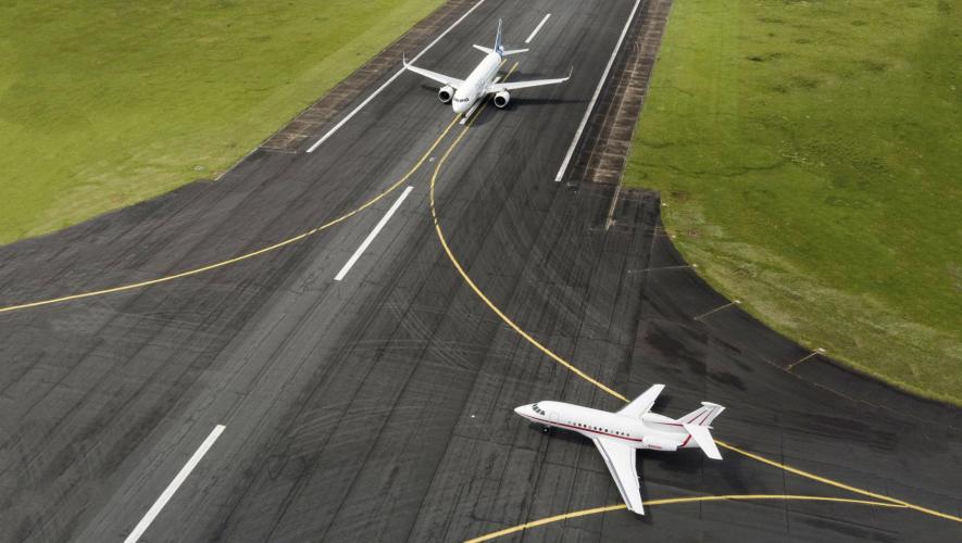 Airbus A320neo on runway with Dassault Falcon 900EX entering runway