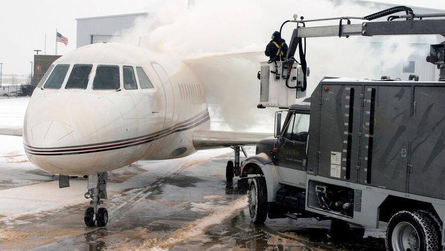 Business jet being deiced