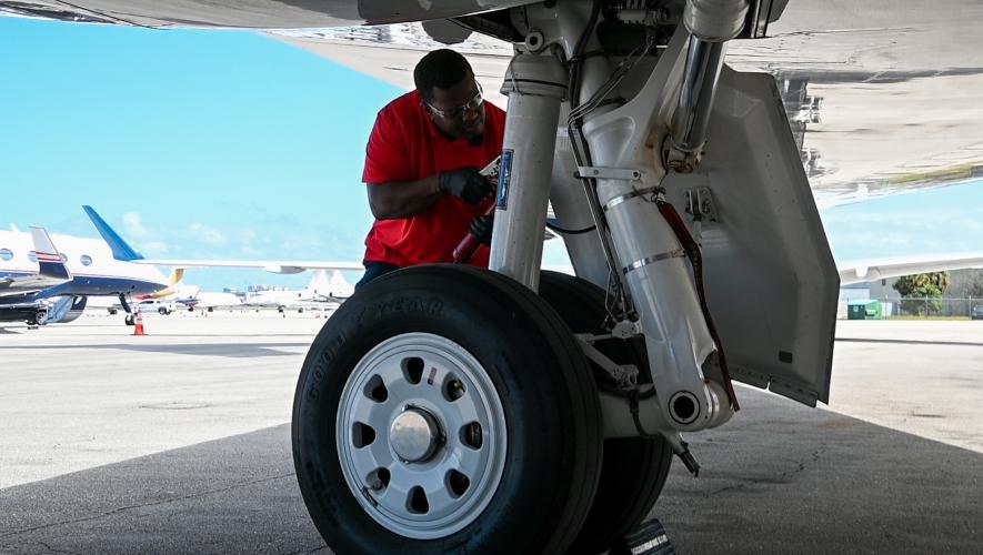 A Jet East mechanic works on landing gear