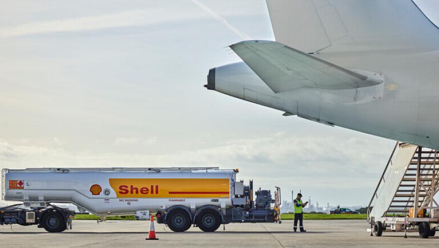 A Shell Aviation fuel tanker is pictured next to an airplane