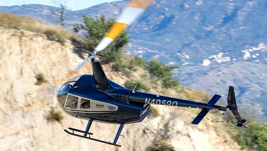 A Robinson R66 helicopter is pictured in flight.