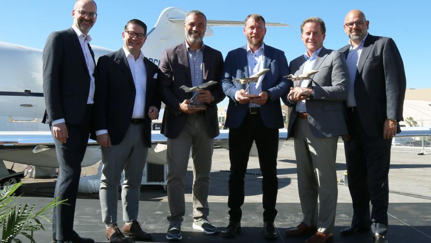 Bombardier executives and AB Jets leadership celebrate 3 ship order at NBAA