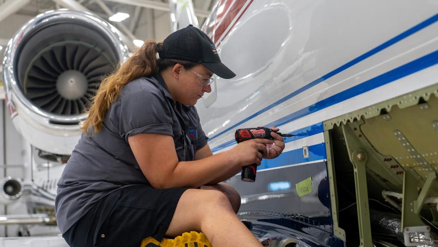 A Textron apprentice works on a business jet