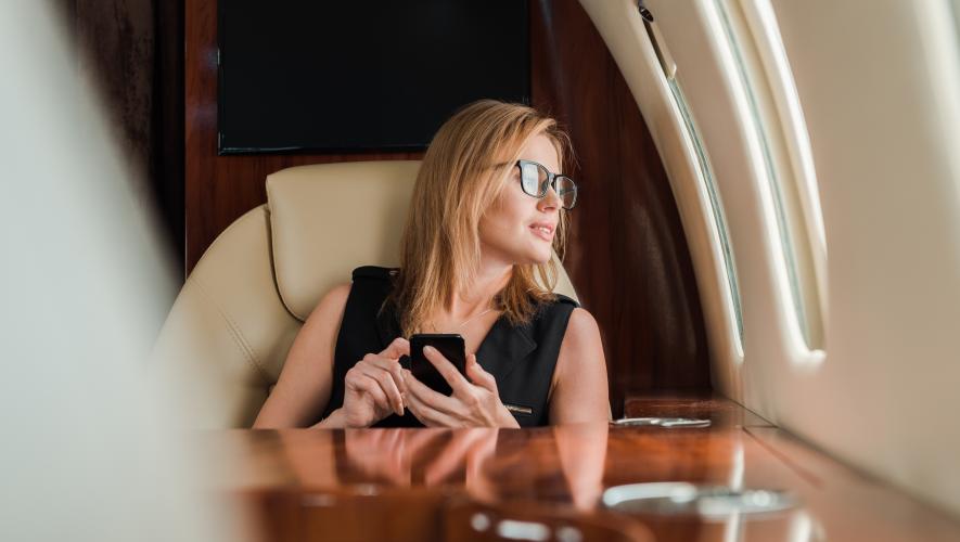 Generic woman aboard private jet (Adobe Stock)