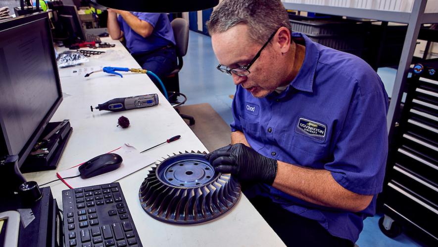 Covington Aircraft Engines technician working on turbine blades