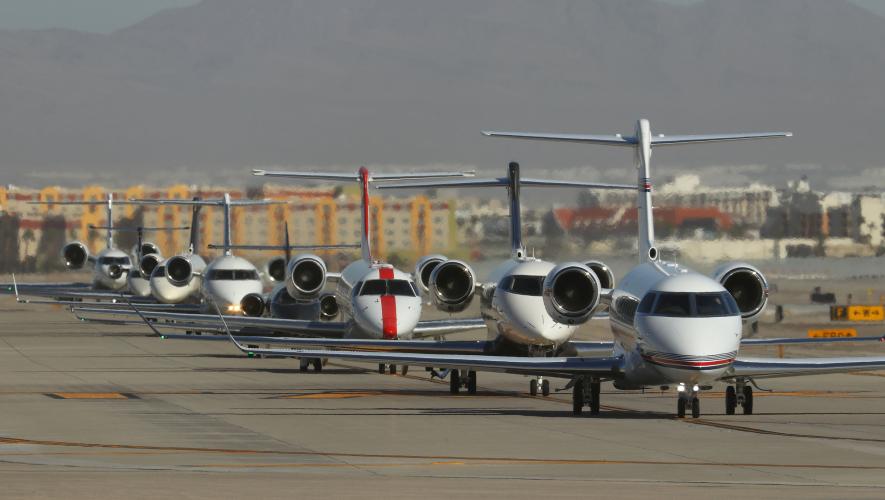 Business jets lined up on taxiway