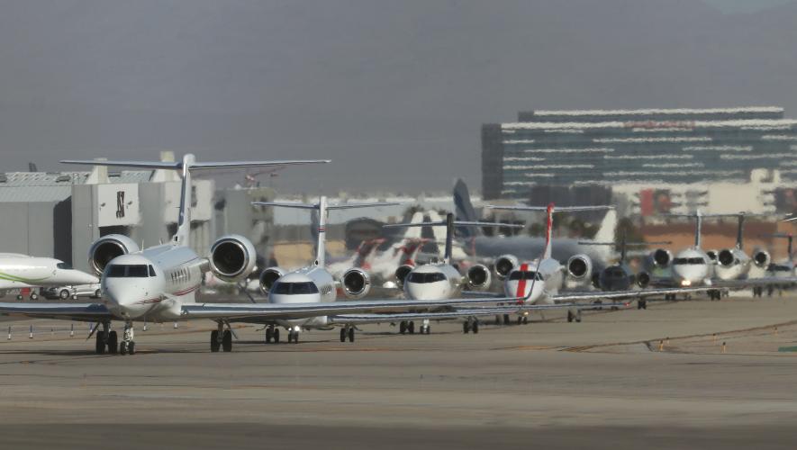 Private jets lined up on ramp at KLAS