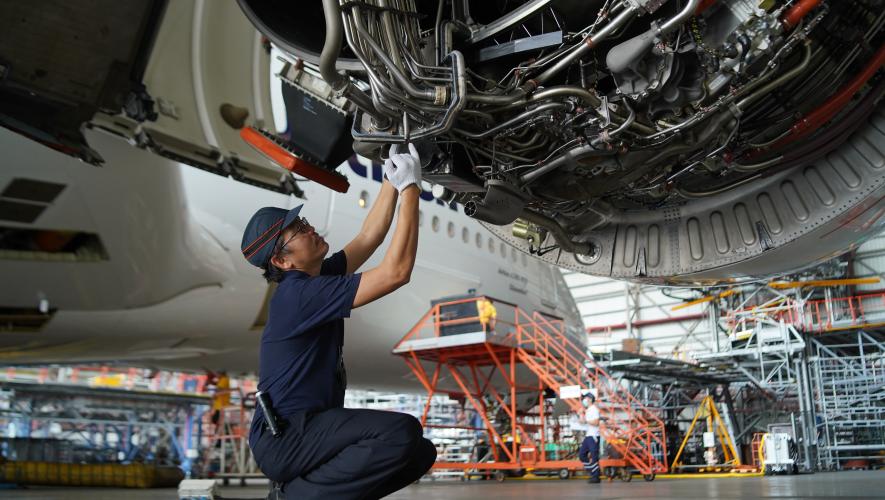 A Lufthansa Technik mechanic inspects an engine in Manila 