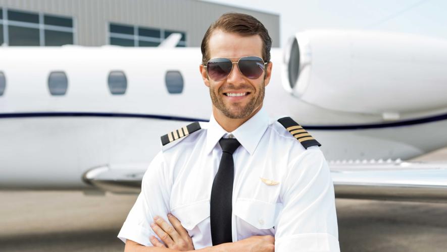 Pilot in front of business jet