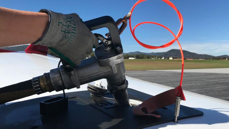 close-up of refueling nozzle into wing