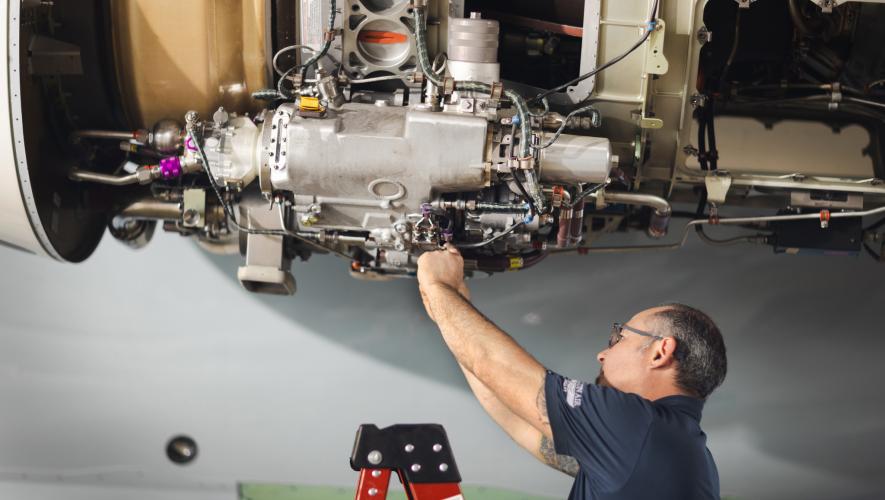 maintenance technician working on aircraft engine