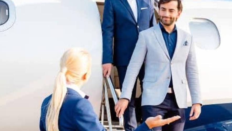 Passengers deboarding business jet greeted by cabin crew