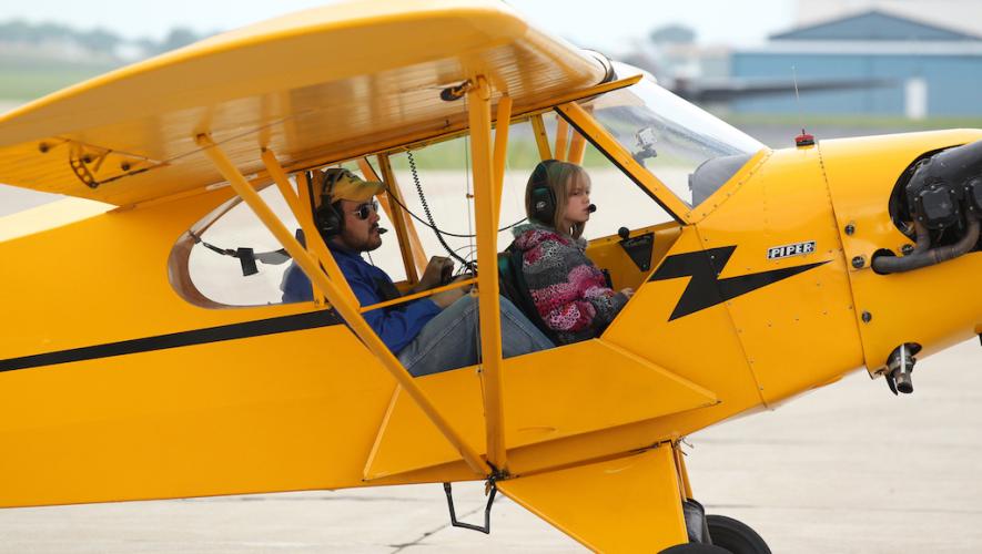 EAA Member pilot and youth in Piper Cub airplane for Young Eagles program flight
