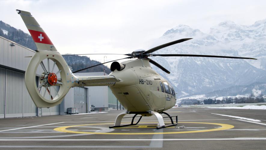 Leonardo AW09 single-turbine-engine prototype PS4 on helipad in front of hangars