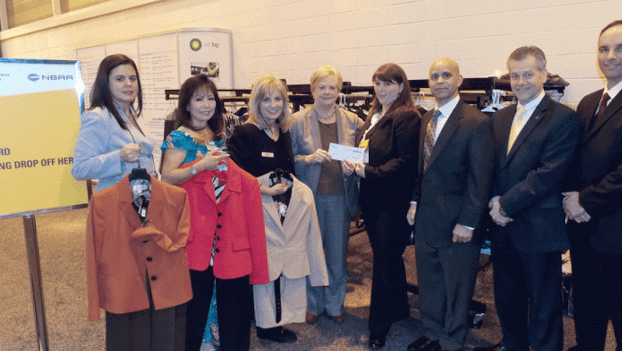 Spring Adamo (fourth from right) presents check to Midge Donald for Dress for Success New Orleans (Photo: Curt Epstein)