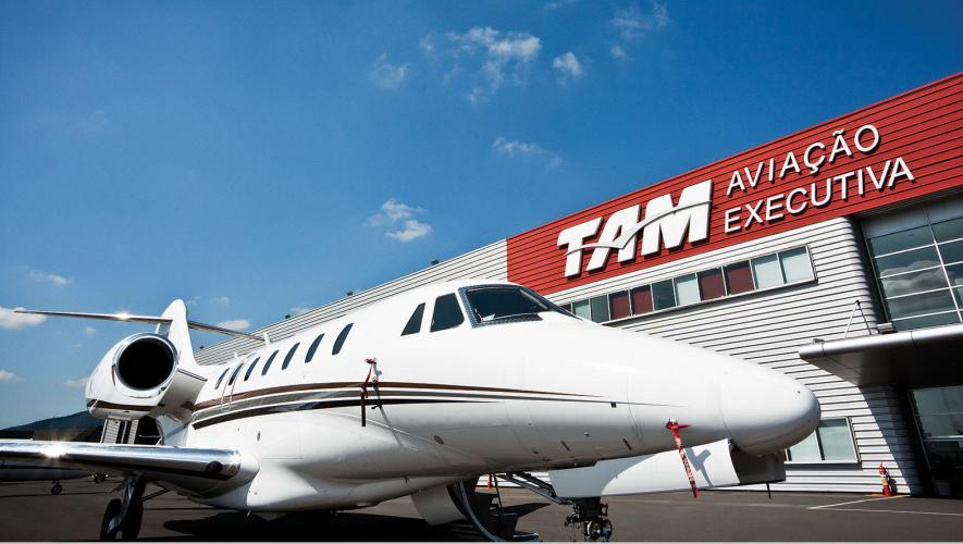Exterior of TAM Aviação Executiva FBO with business jet parked in front