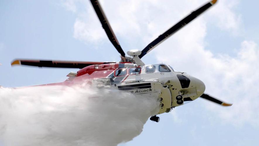 Leonardo AW139 Firefighting helicopter dropping water overhead