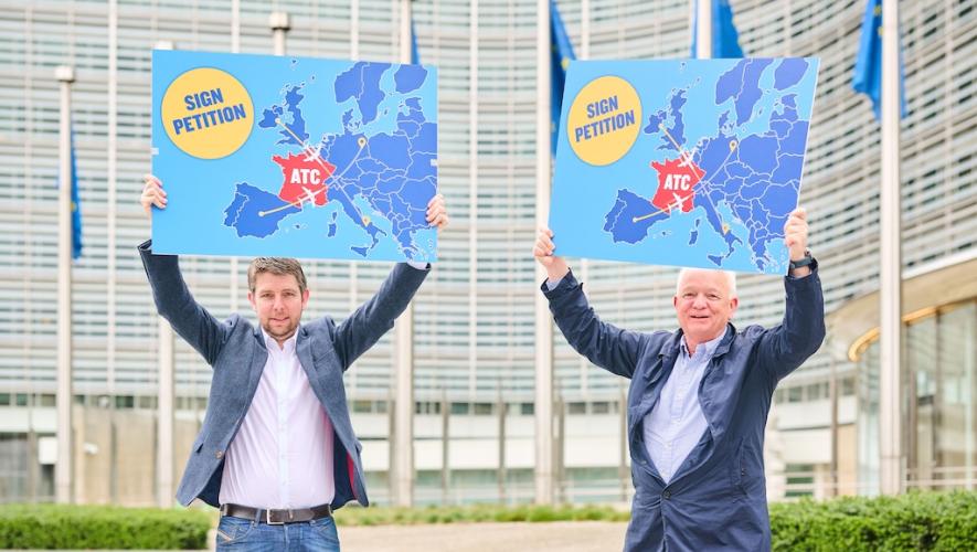 Ryanair director of operations Neal McMahon (left) and CEO Eddie Wilson hold signs calling for customers to sign a petition to allow for French overflights while air traffic controllers in the country stage strikes. 