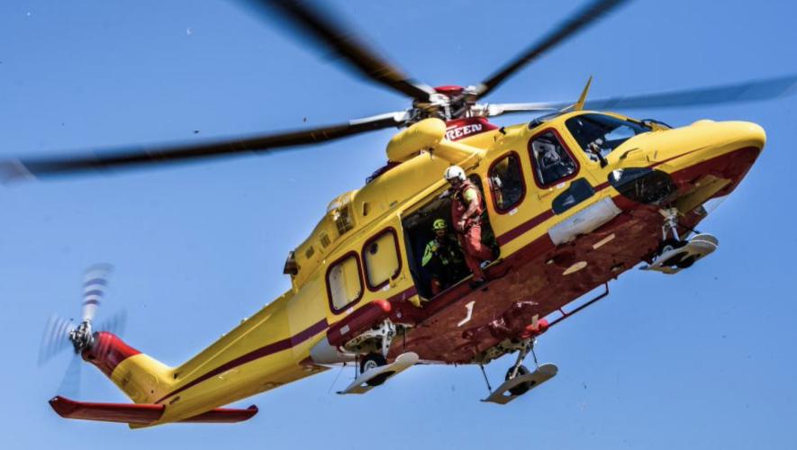 Med Rescue Agusta AW139 helicopter in flight with crew at open side door