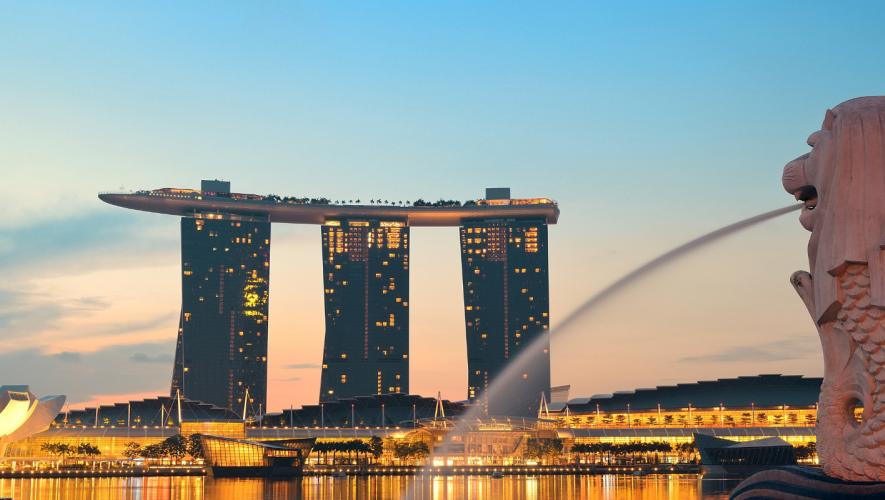 View from Merlion Park in Singapore with airliner passing over Marina Bay Sands