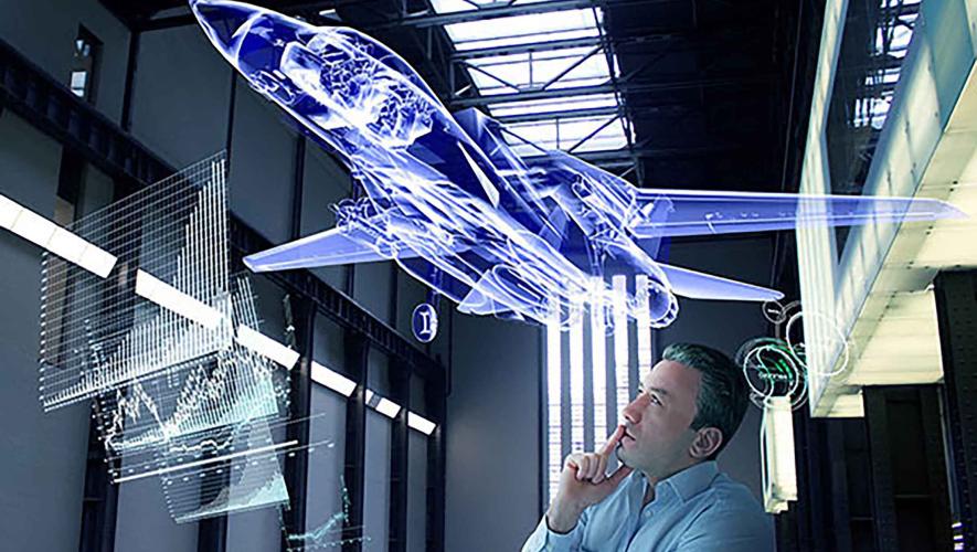 An engineer looks at a holographic diagram of an airplane