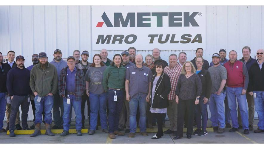 Ametek MRO Drake Air staff in front of sign at its Tulsa, Oklahoma facility