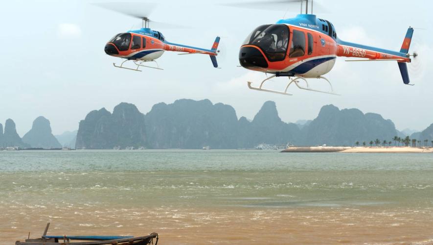 VNH Bell 505 helicopters in flight over Ha Long Bay in Vietnam