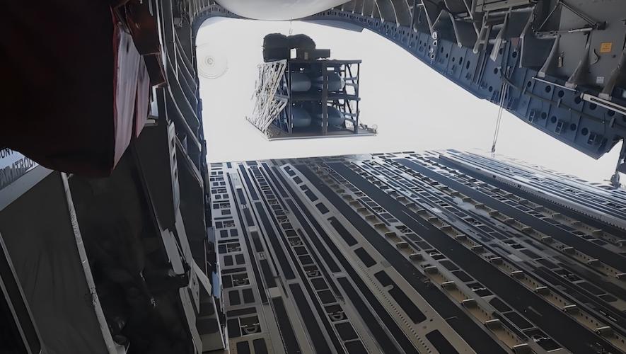 A standard cargo version of the Palletized Munition Deployment System drops from a C-17A. (Photo: Air Force Research Laboratories)