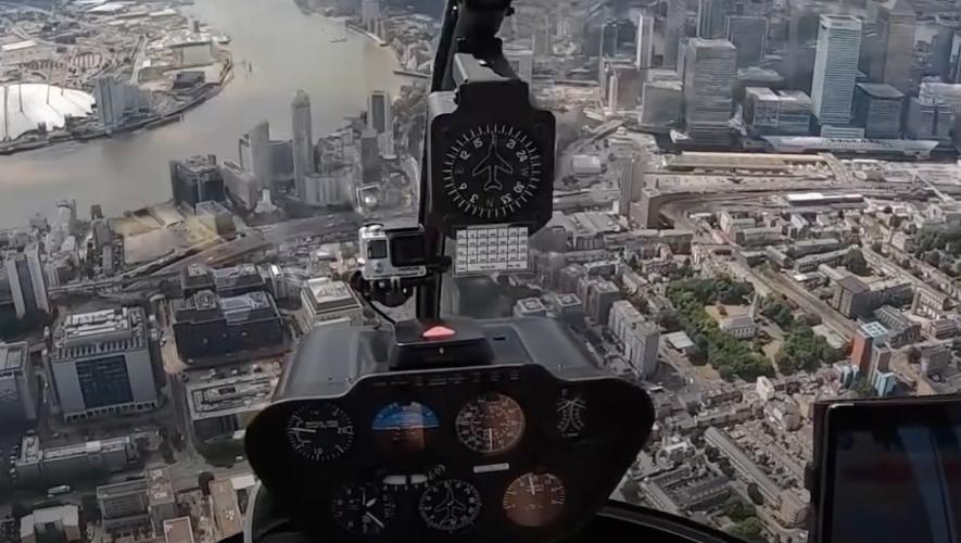 view from helicopter flight deck in flight over city
