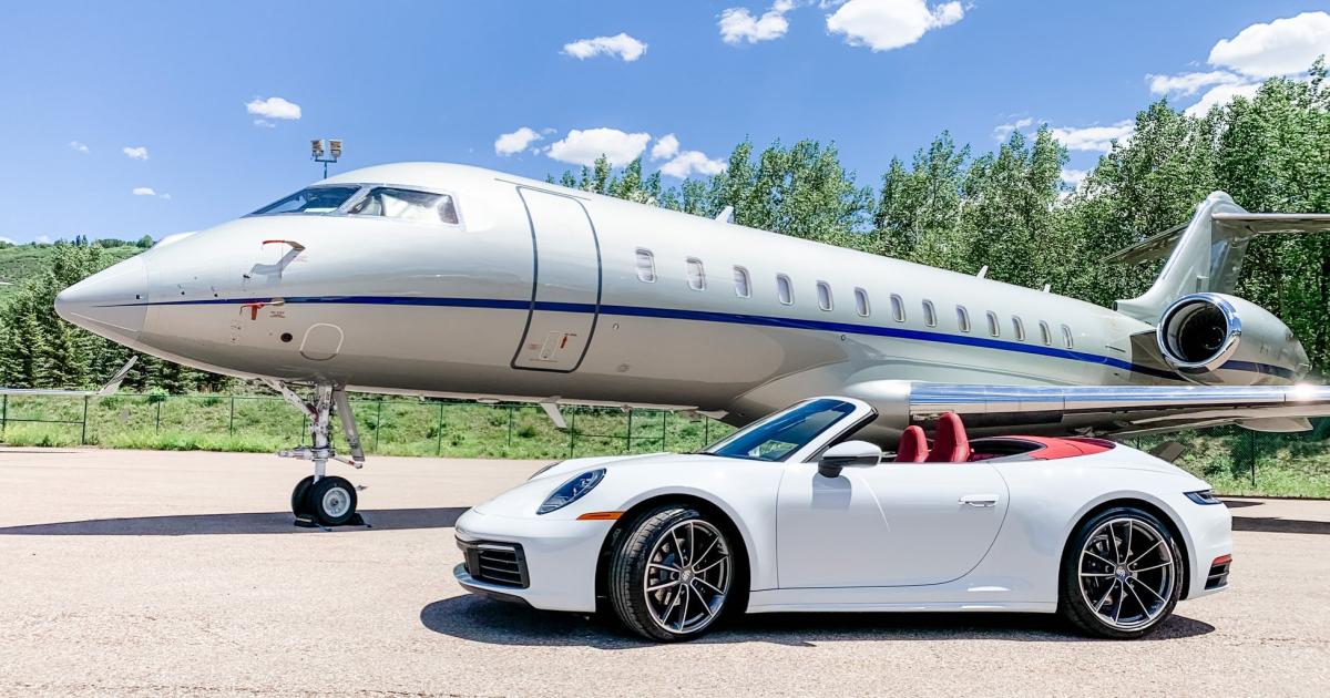 2020 white Porche 911 convertible with red interior and Bombardier Global Express business jet on airport ramp 