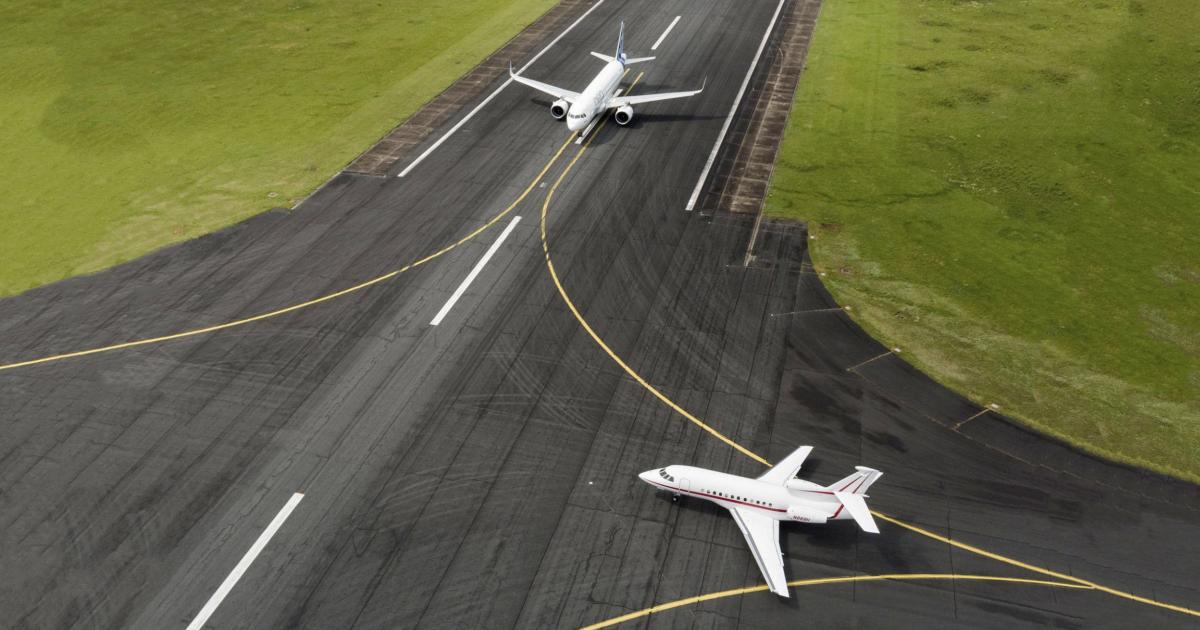 Airbus A320neo on runway with Dassault Falcon 900EX entering runway