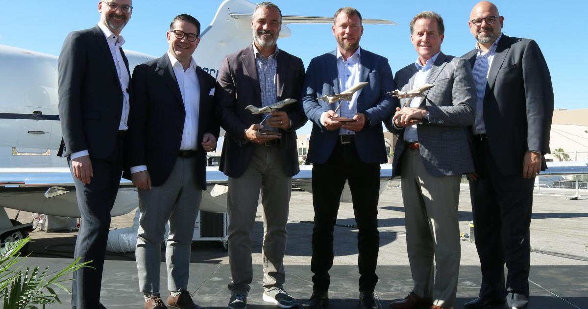 Bombardier executives and AB Jets leadership celebrate 3 ship order at NBAA