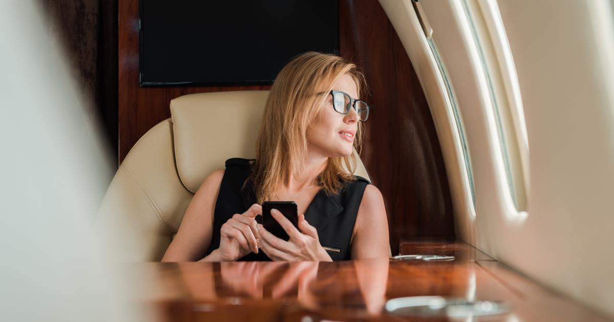 Generic woman aboard private jet (Adobe Stock)