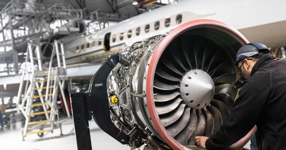 Dassault mechanic works on a PW307 turbofan
