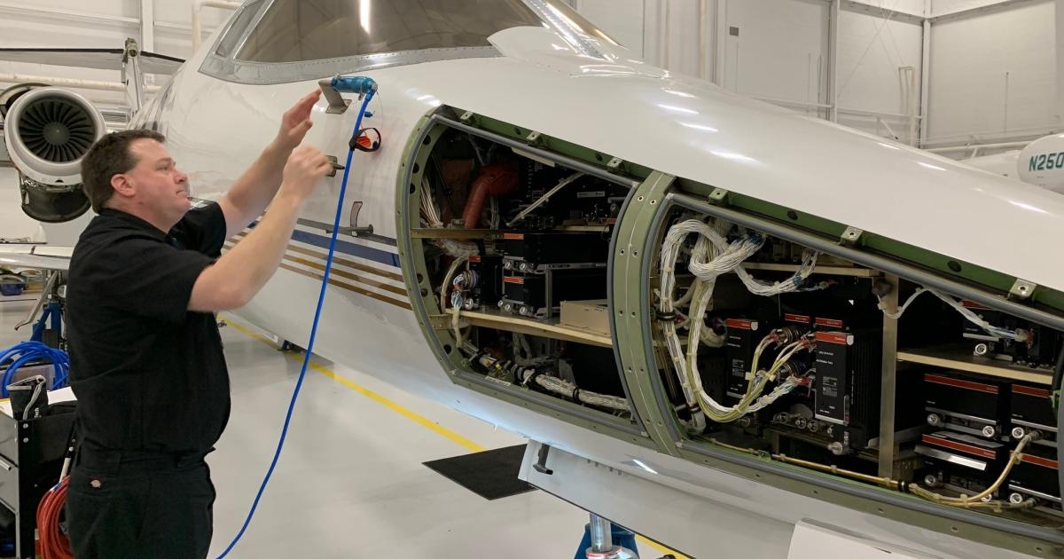A PJM mechanic performs avionics maintenance