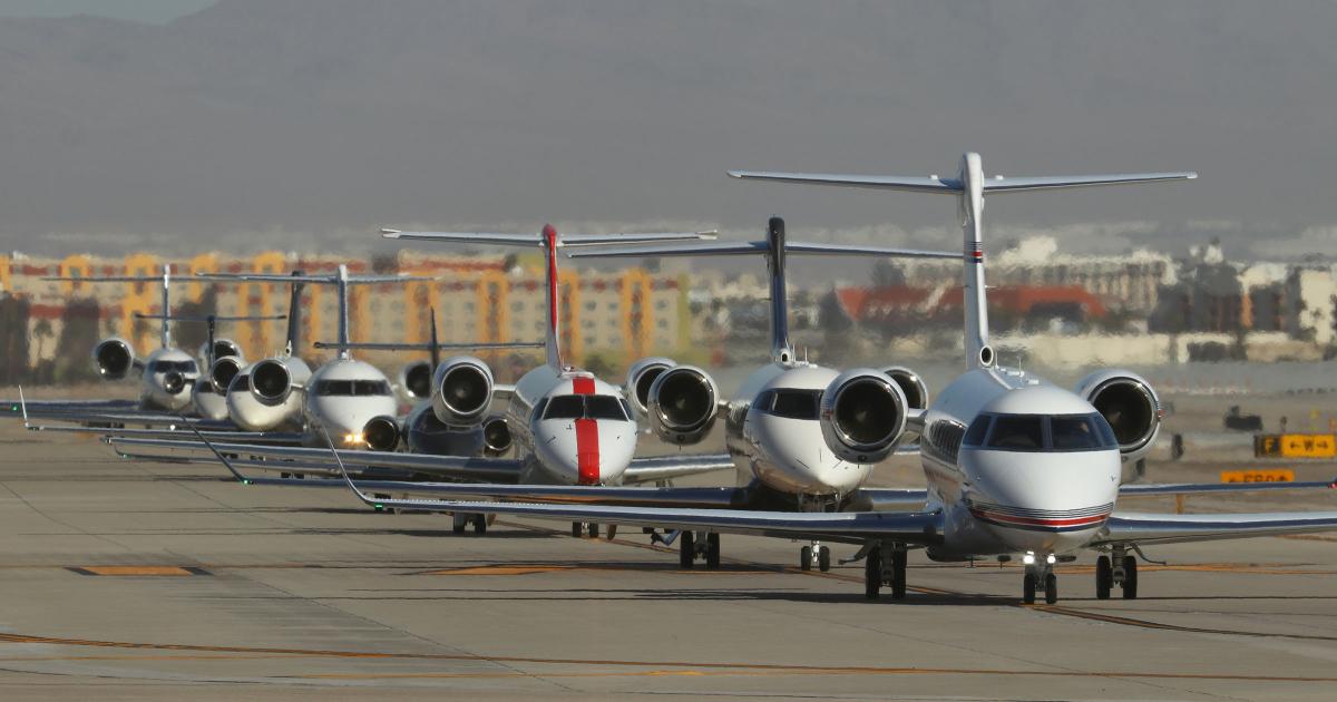 Business jets lined up on taxiway