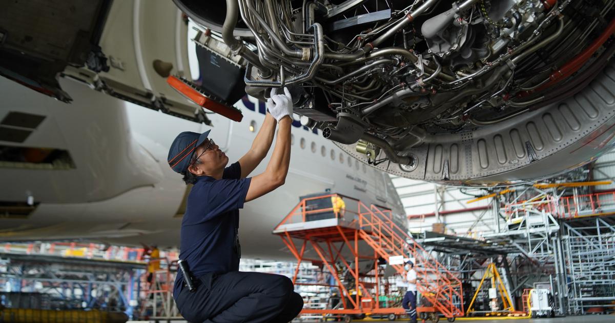 A Lufthansa Technik mechanic inspects an engine in Manila 