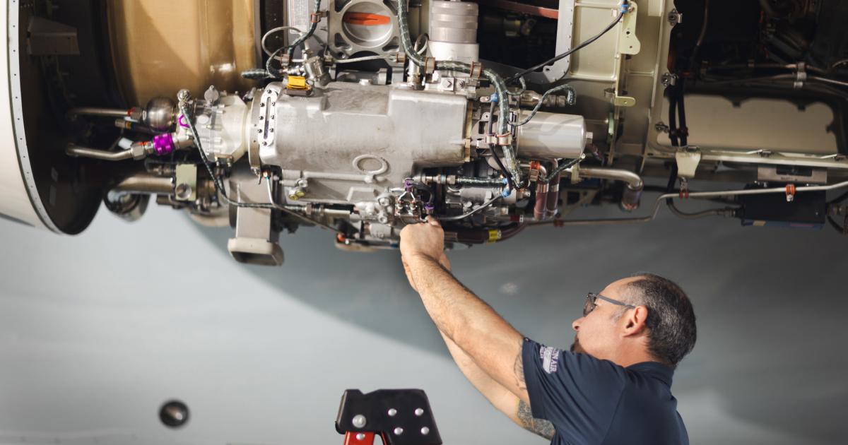 maintenance technician working on aircraft engine