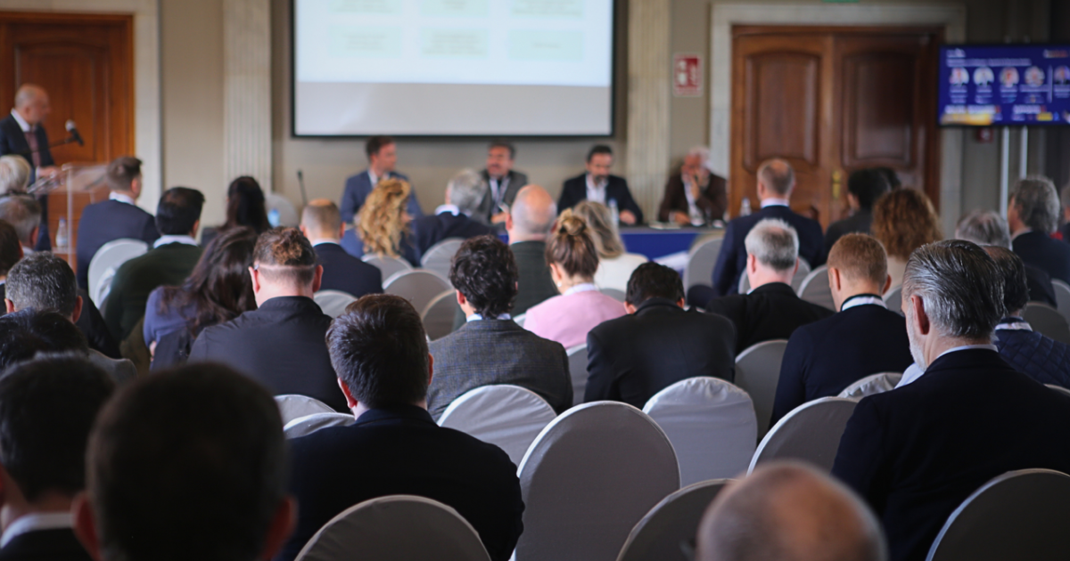 Room of delegates sit in presentation 