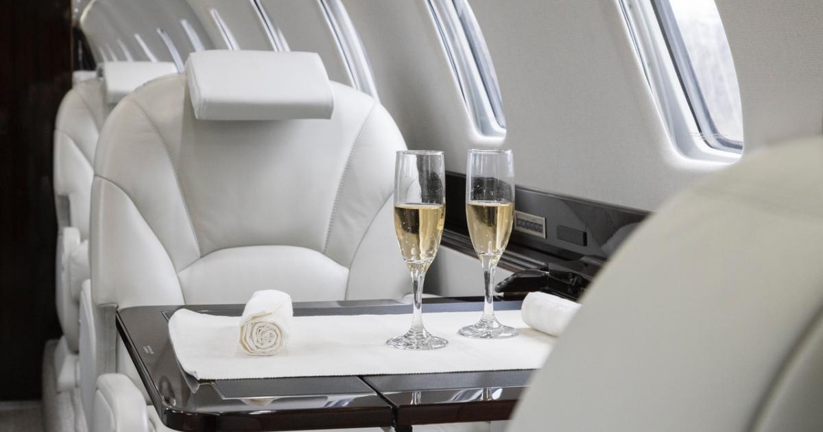 private jet interior with two glasses of champagne