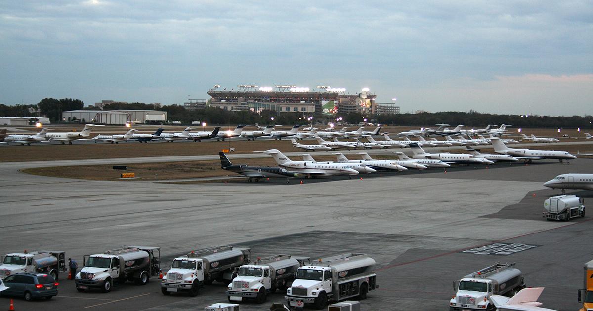airport with parked jets and football stadium in background